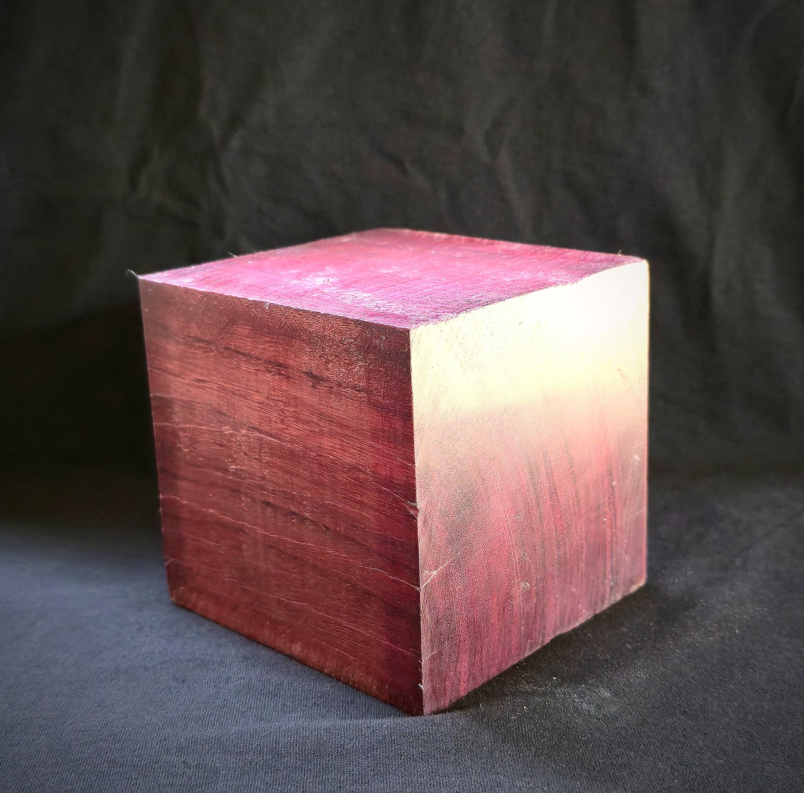 Raw purpleheart cube blank — before engraving