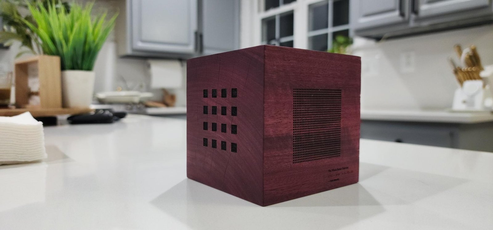 Finished cube with Anik Malcolm's hand engraving on the lower right face — laser-cut grids visible